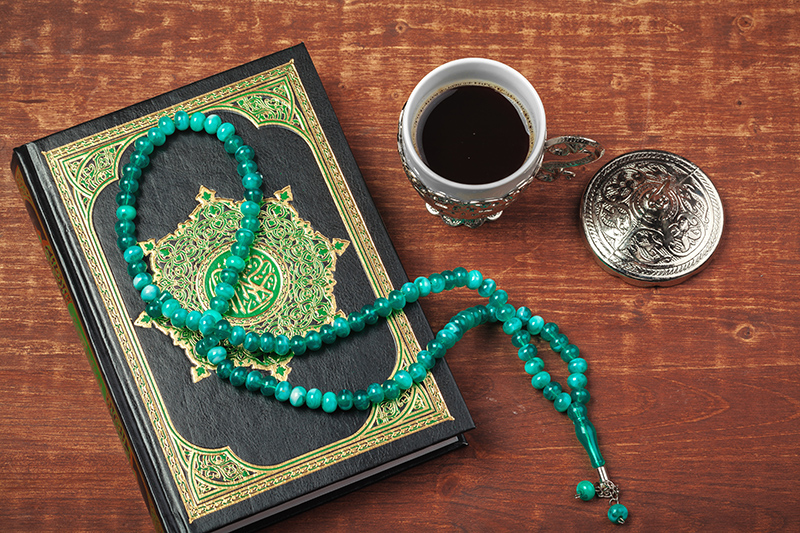 holy quran with beads over wooden background close 2023 11 27 05 13 18 utc